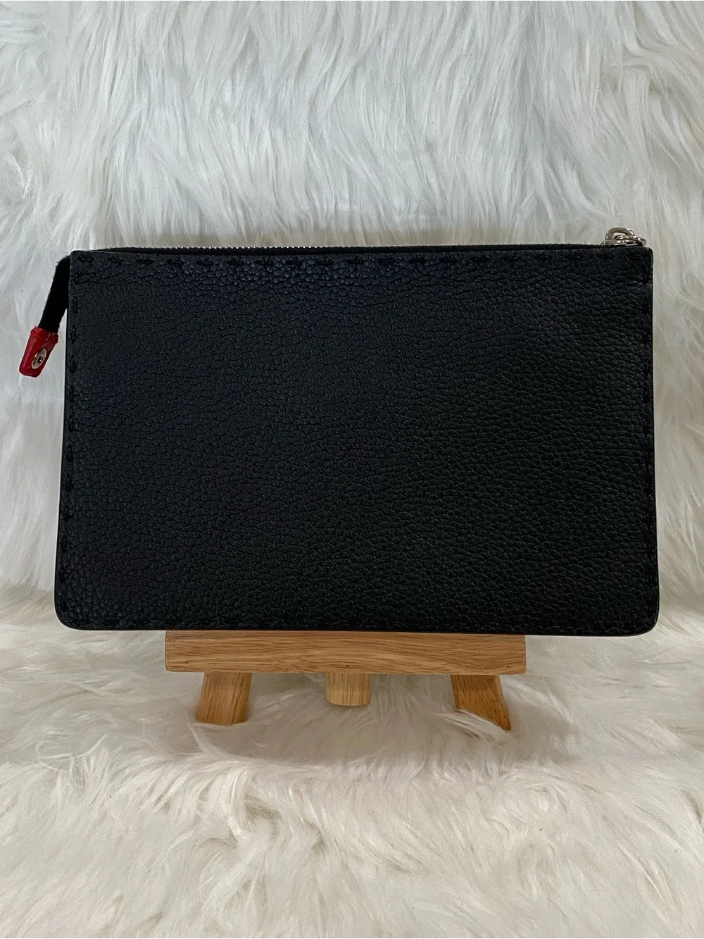 Fendi Selleria flat clutch bag with red stitching and red leather handle